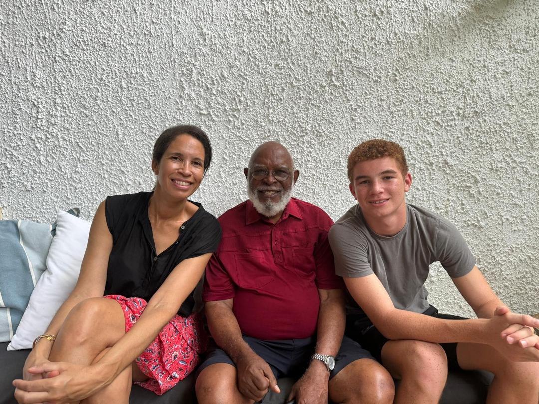 Grandpa Ole seated with family and a grandson